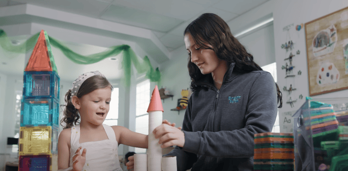 BrightPath-teacher-making-a-rocket-with-a-little-girl-student