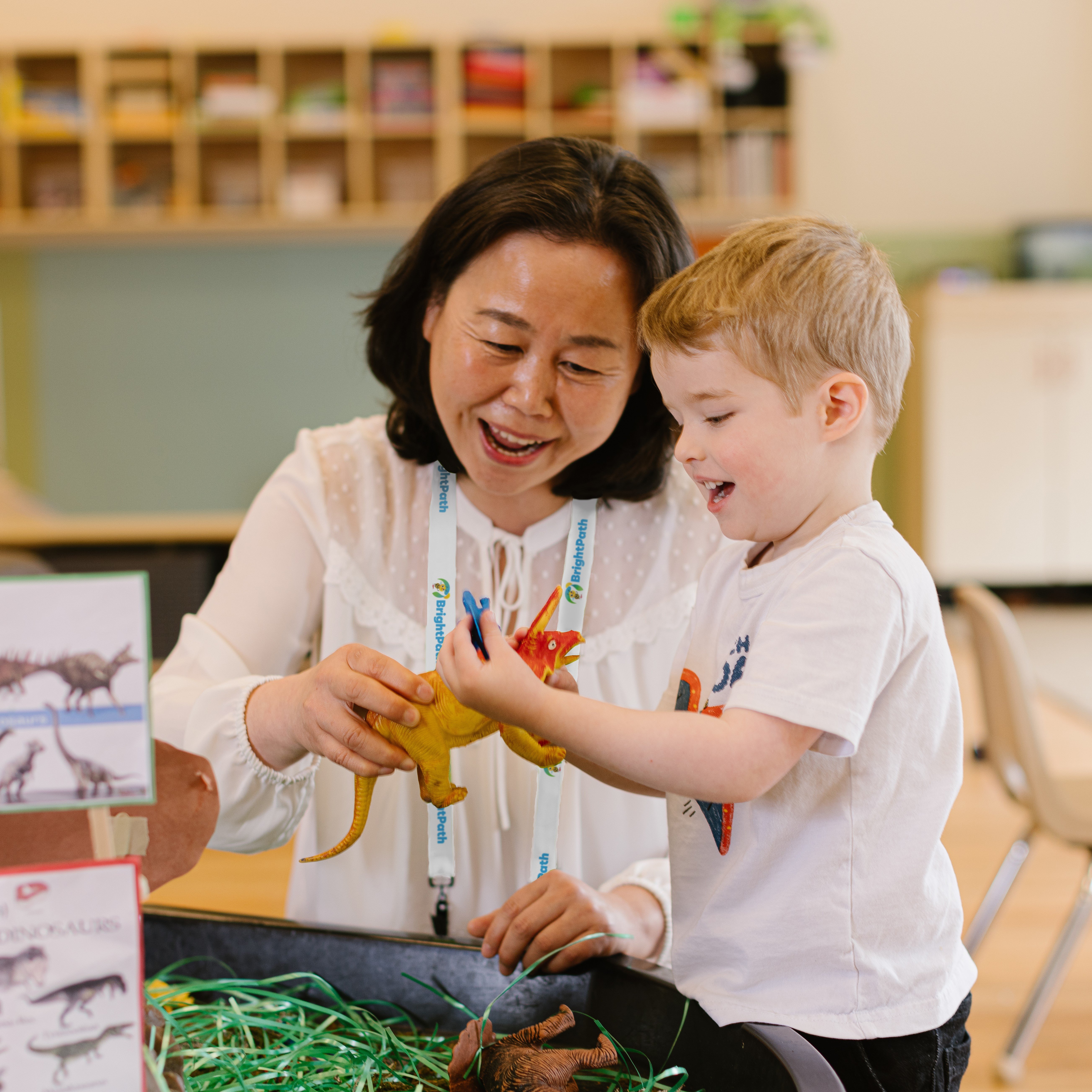 Educator with child and toy dinosaur2