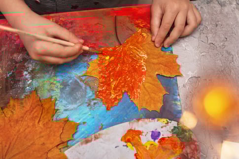 children-s-hands-paint-with-brush-on-autumn-maple-2025-03-07-19-05-10-utc