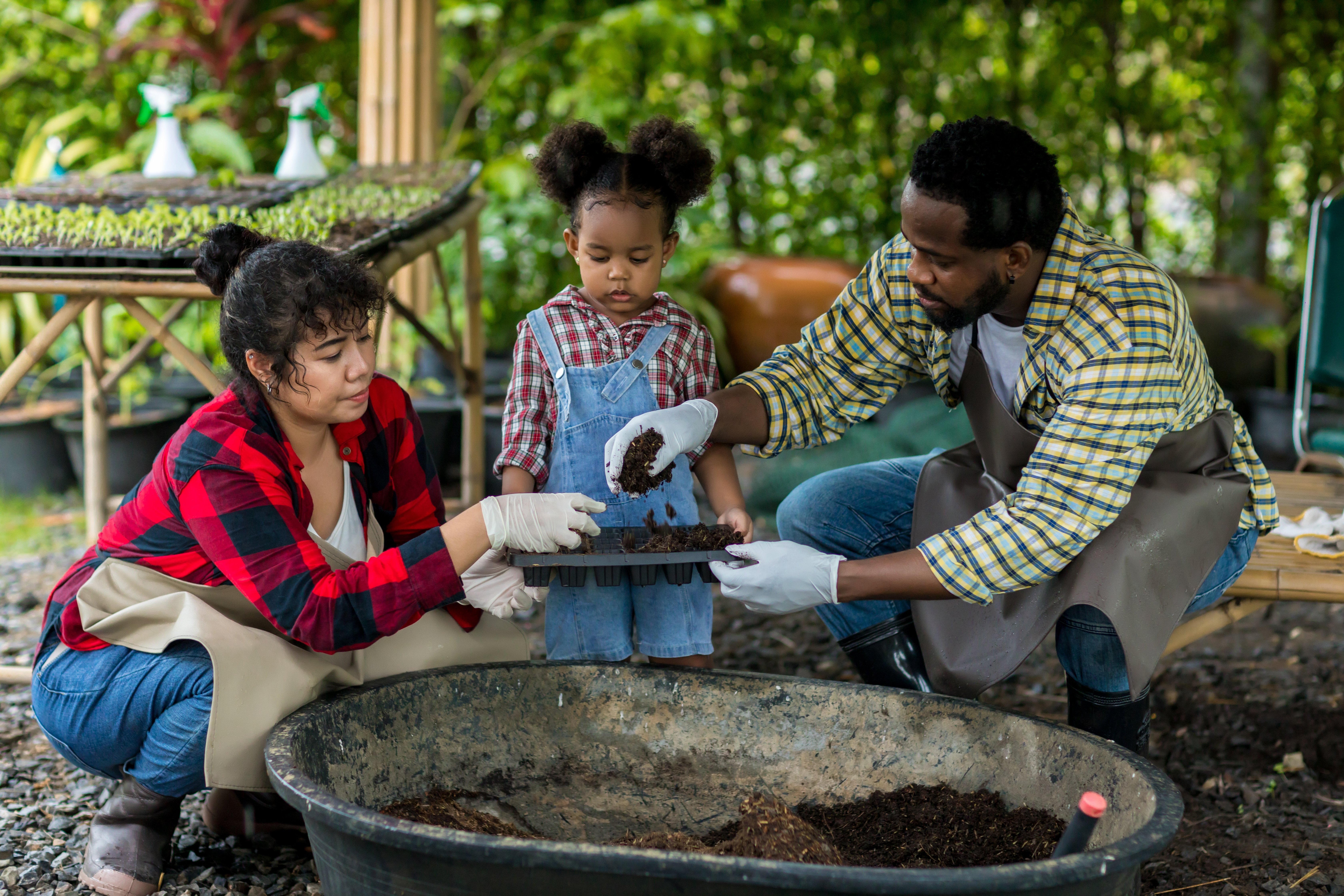 family with young kid gardening together