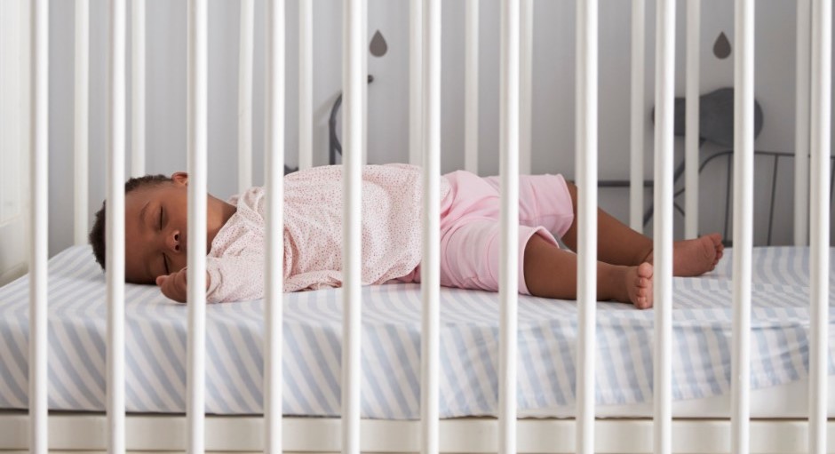 Baby sleeping safe in white crib