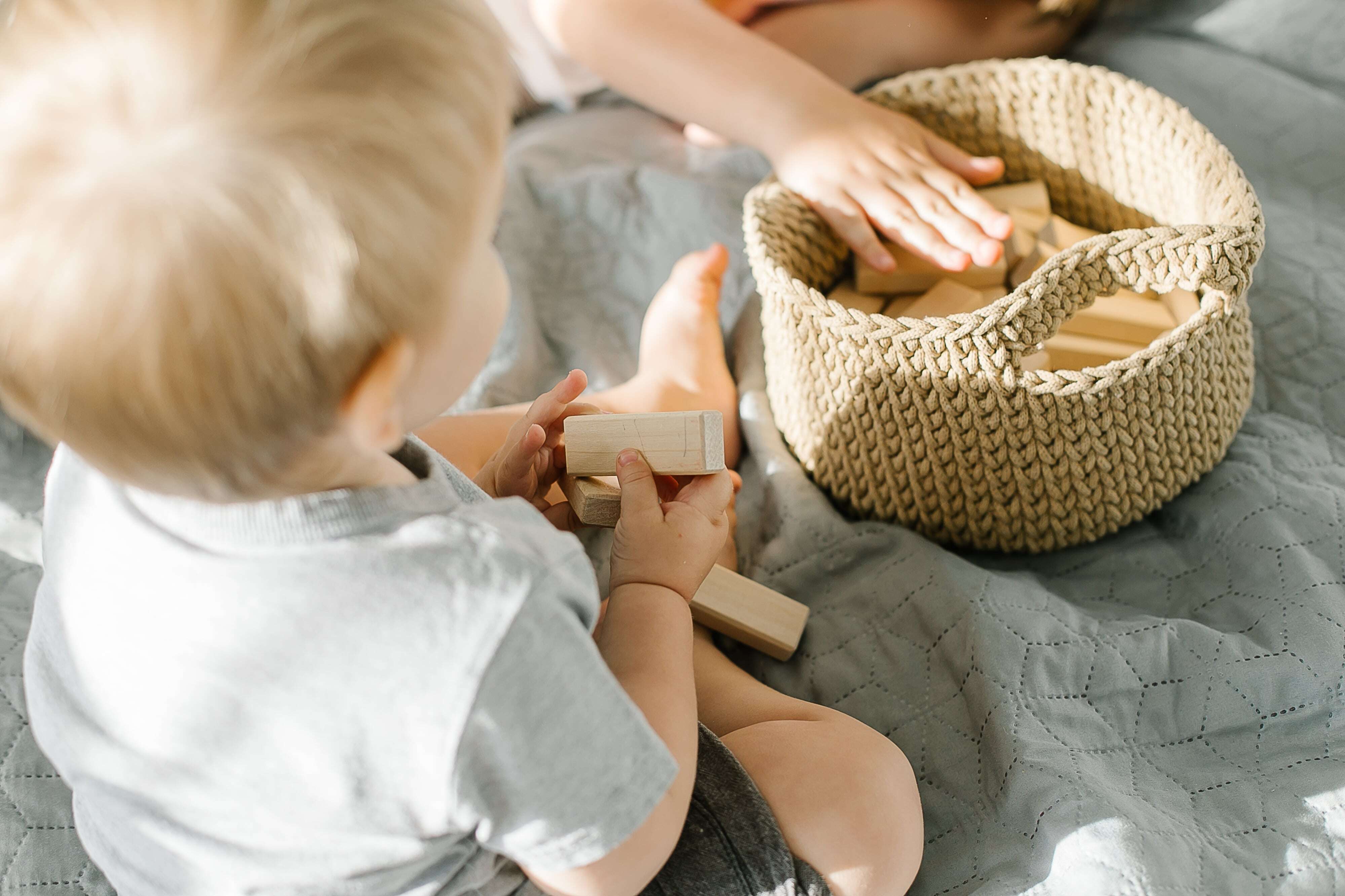 A toddler playing with blocks and building math and STEM skills. 