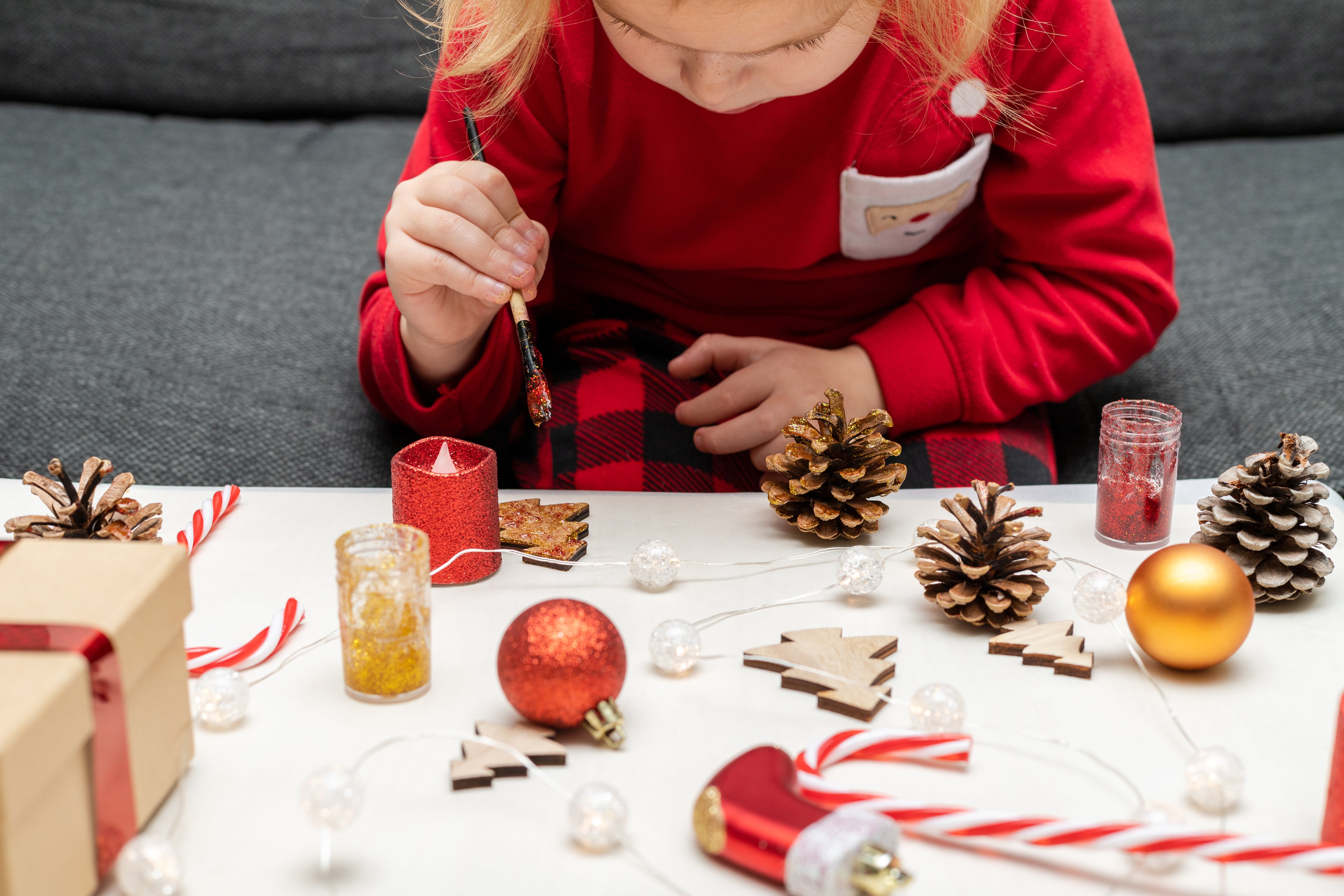 A child enjoying making Christmas crafts at home. 