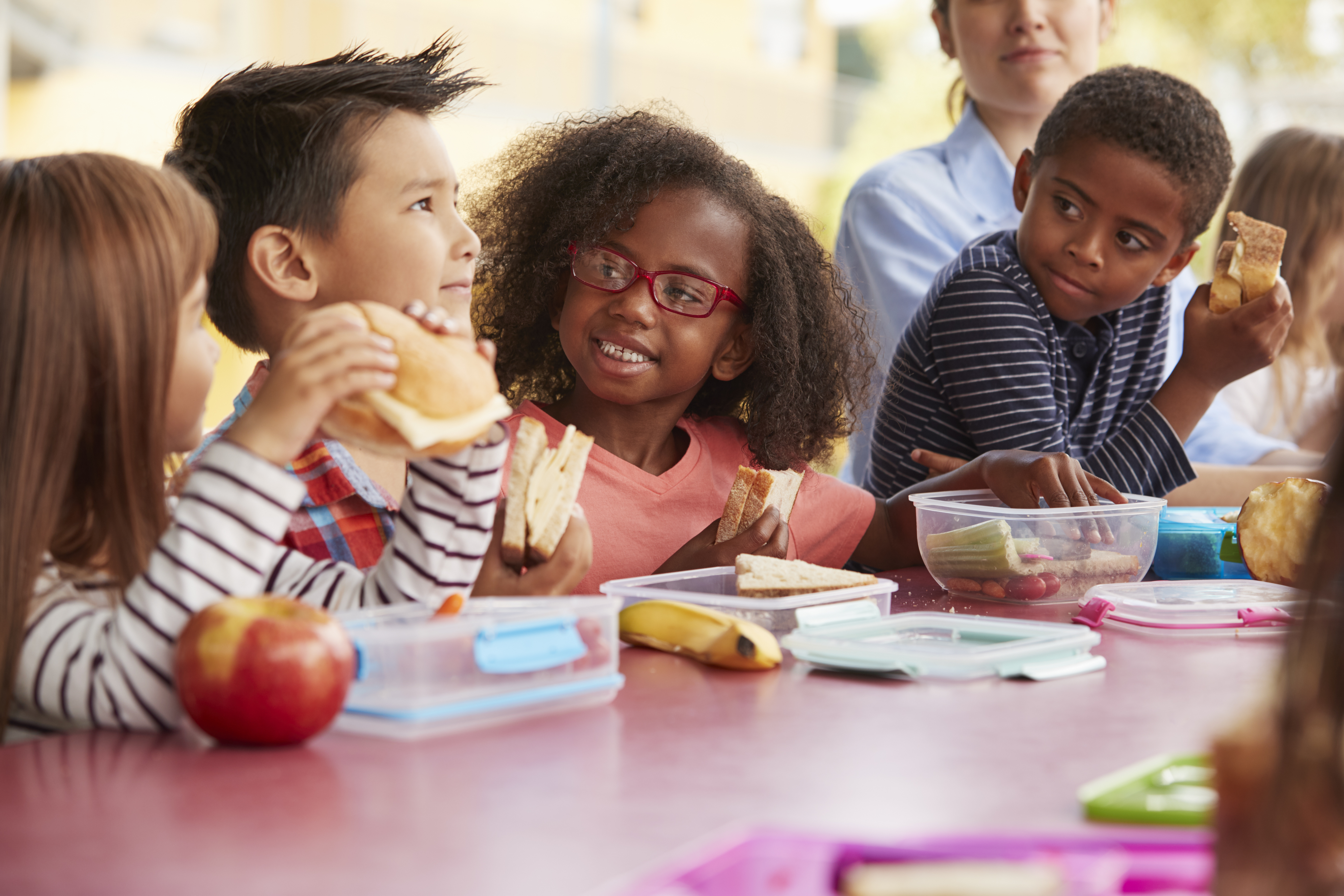 toddlers happy eating lunch together